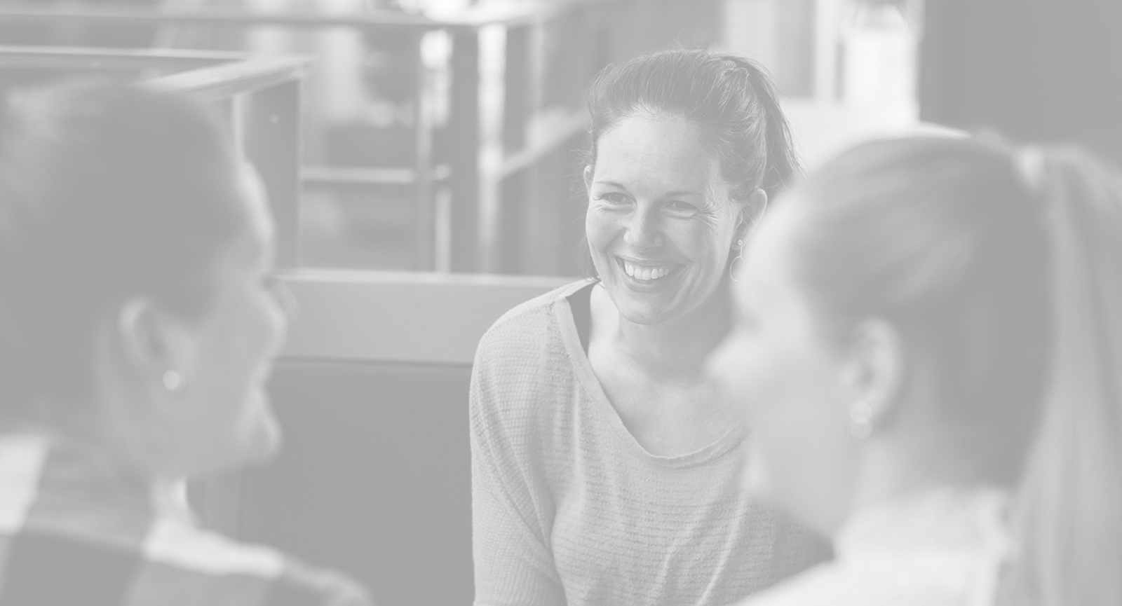 Three girls smiling during the discussion 