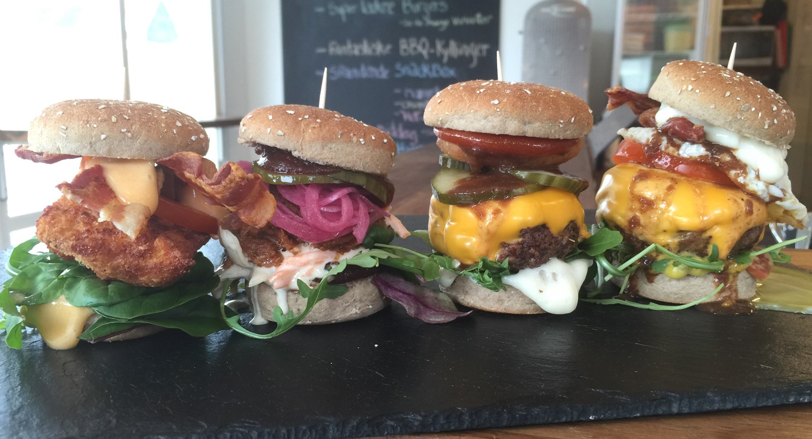 Four burgers with different ingredients