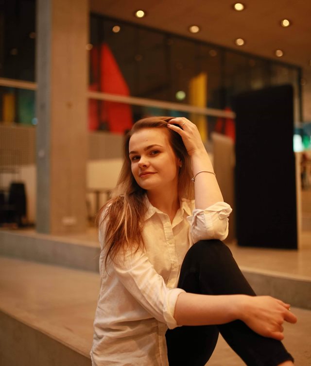 Student holding her hand next to head