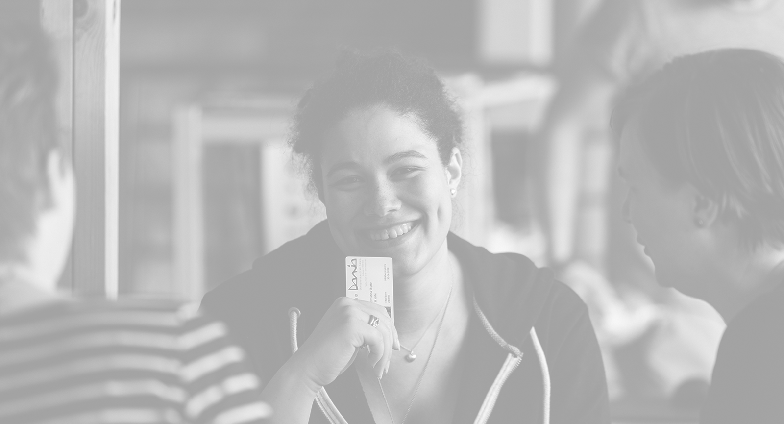 Girl smiling and holding her student card