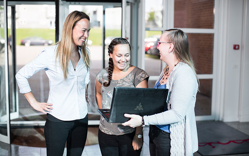 Students meeting with teacher in school