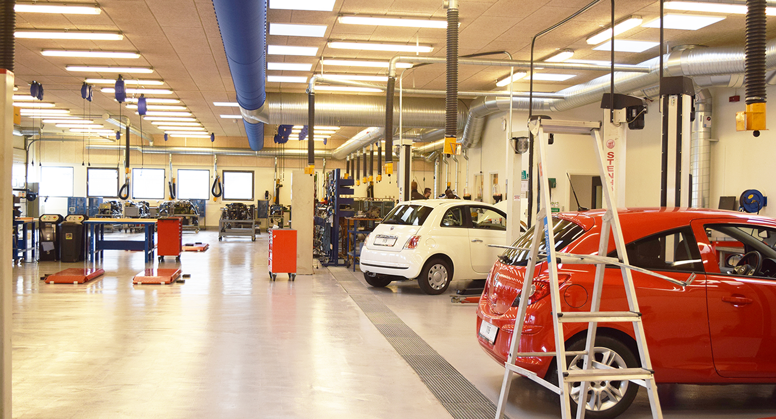 Two cars standing in the workshop organized for Automotive students