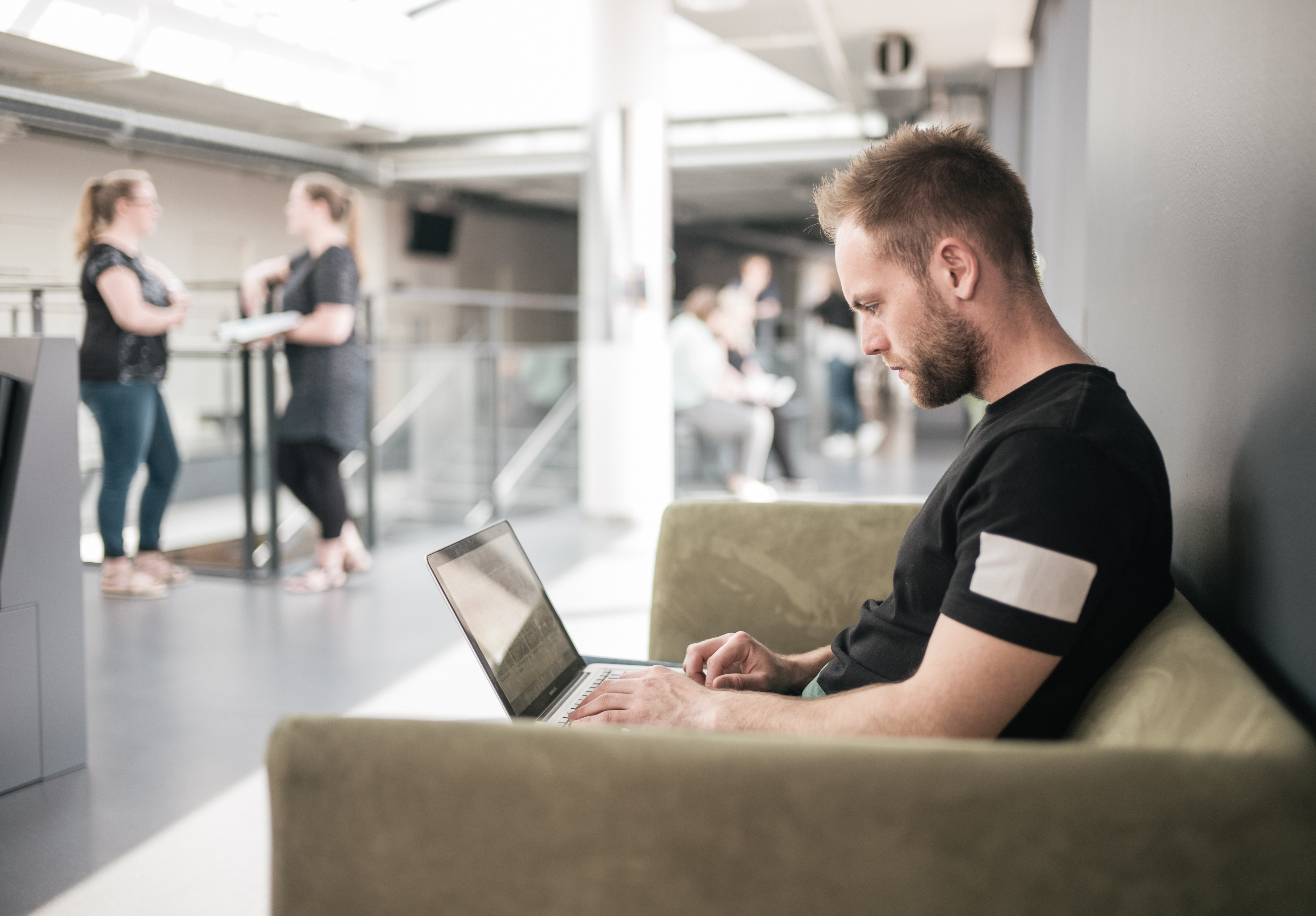 Student using laptop and sitting on the sofa