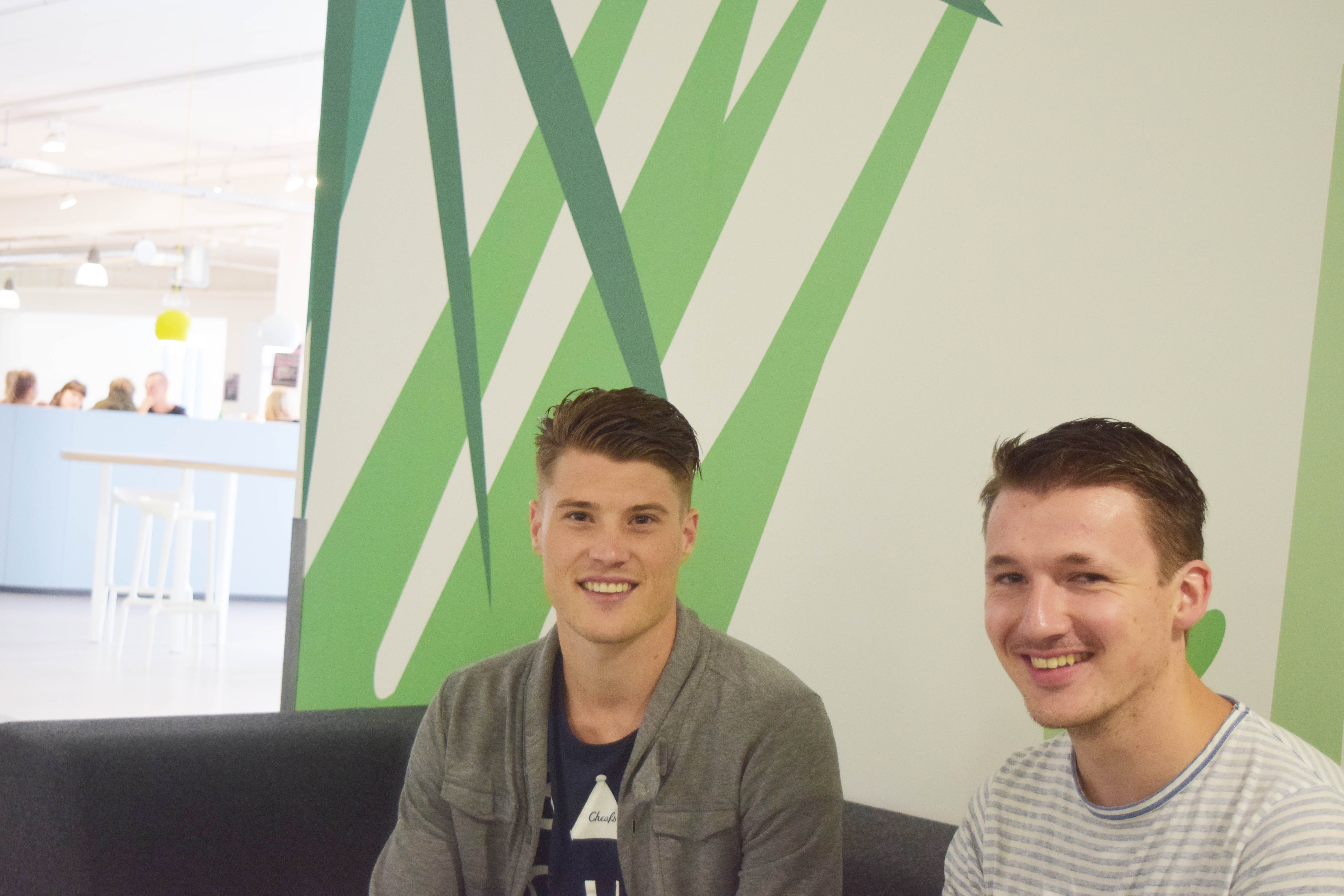 Two young students smiling