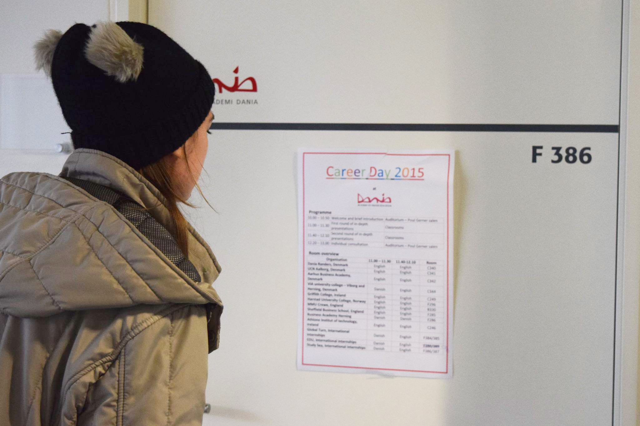 Student reading flyer about career days in Dania