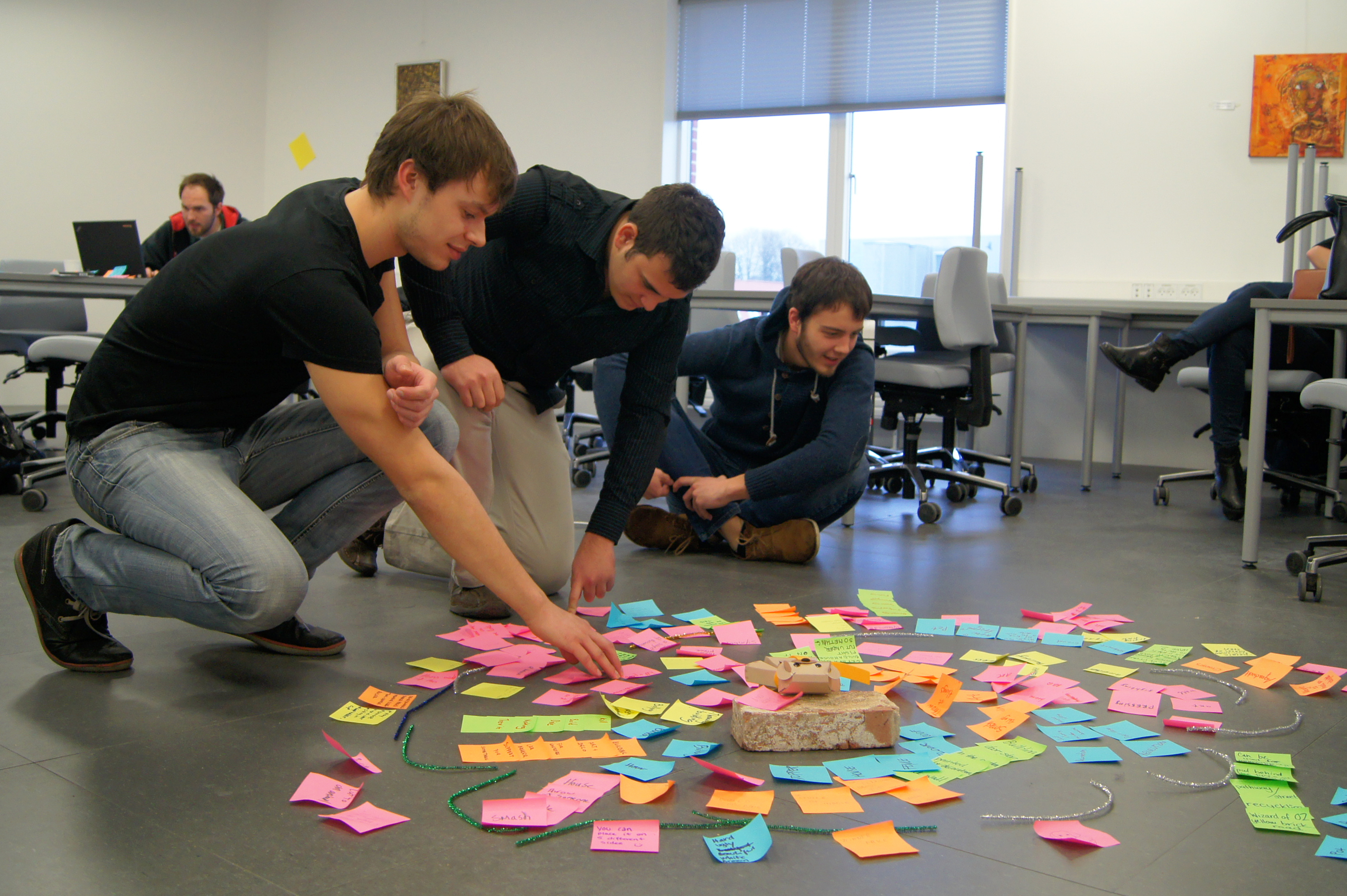 Students creating path on post in paper