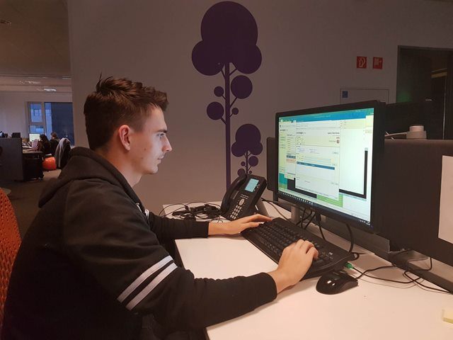 Intern at Dania Academy working on computer