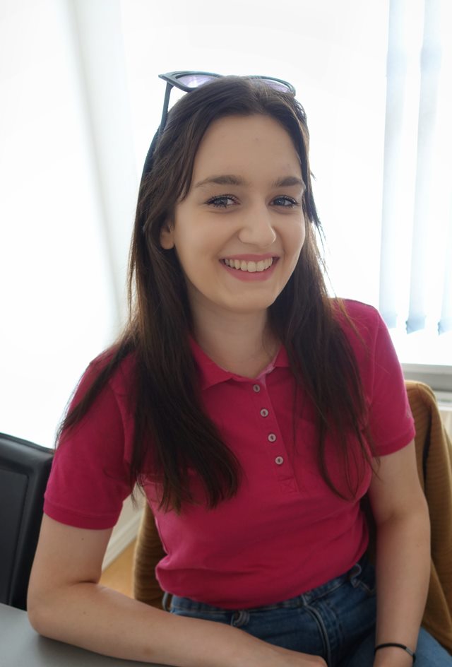 Women smiling and wearing pink t-shirt