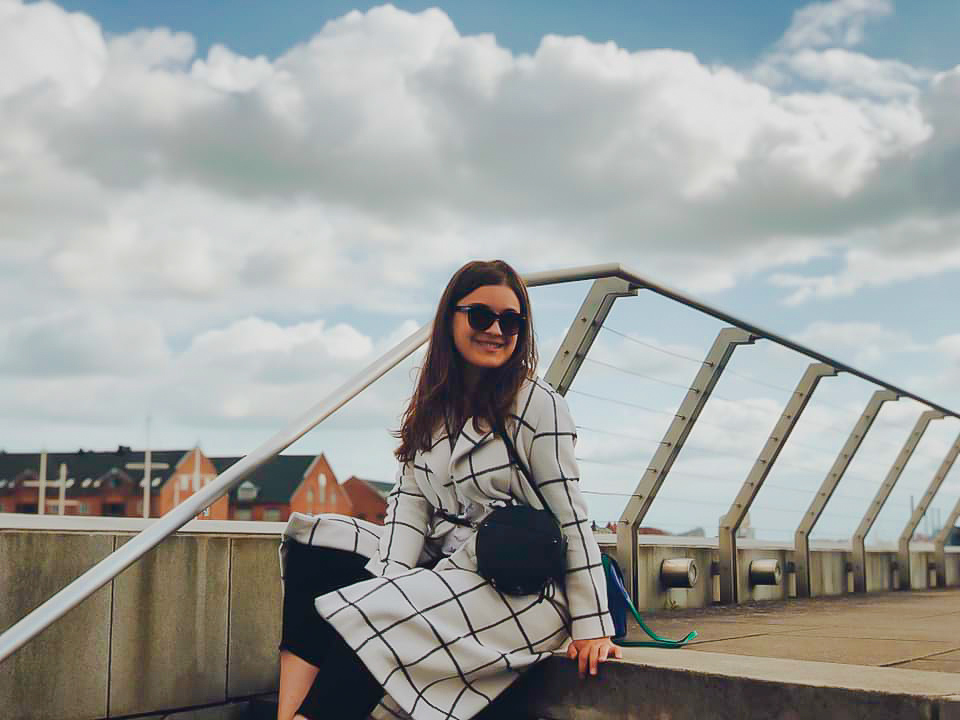 Student sitting on the bridge stairs in Aarhus
