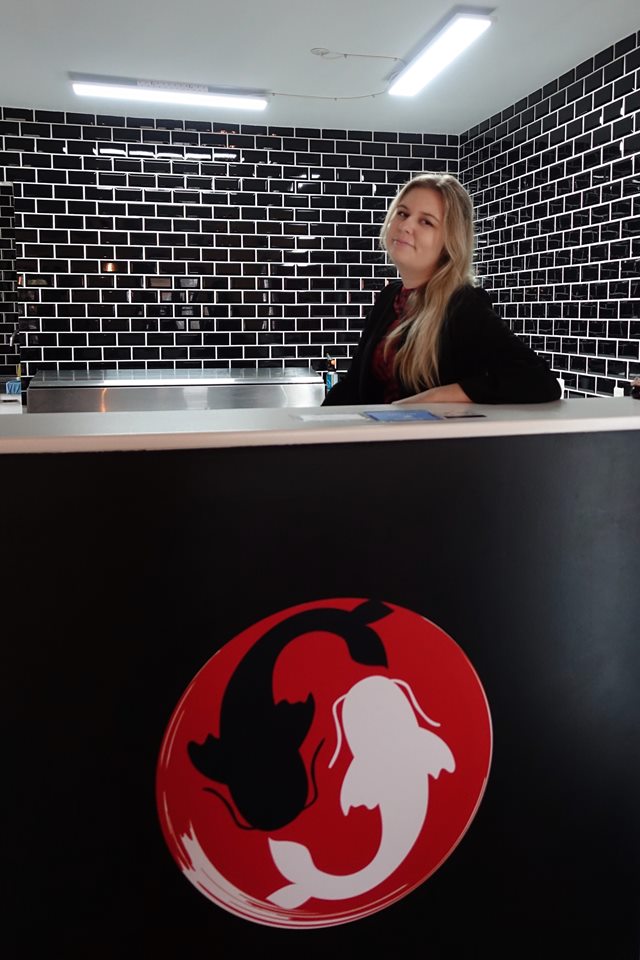 Student standing in restaurant reception 