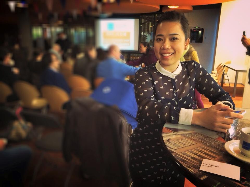 Student sitting in the bar and holding smartphone